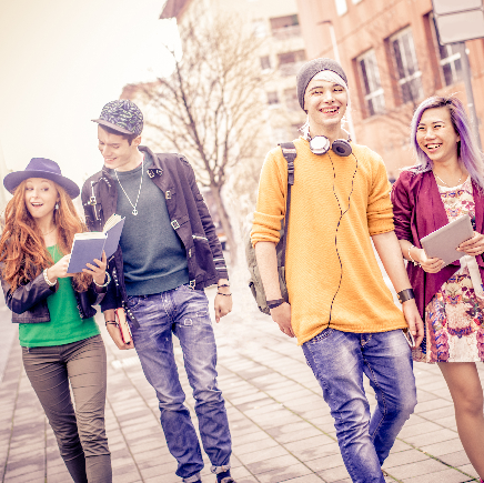 Students walking on campus, smiling
