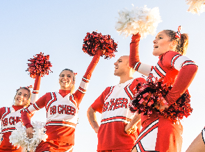 Cheerleaders mid-routine, donning 'big cheer' logos